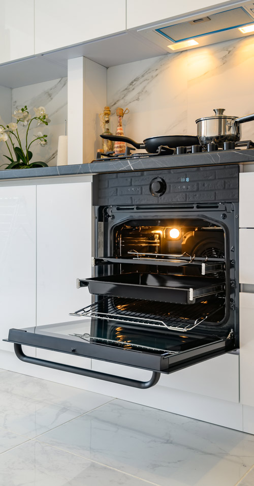 open electric oven at white kitchen